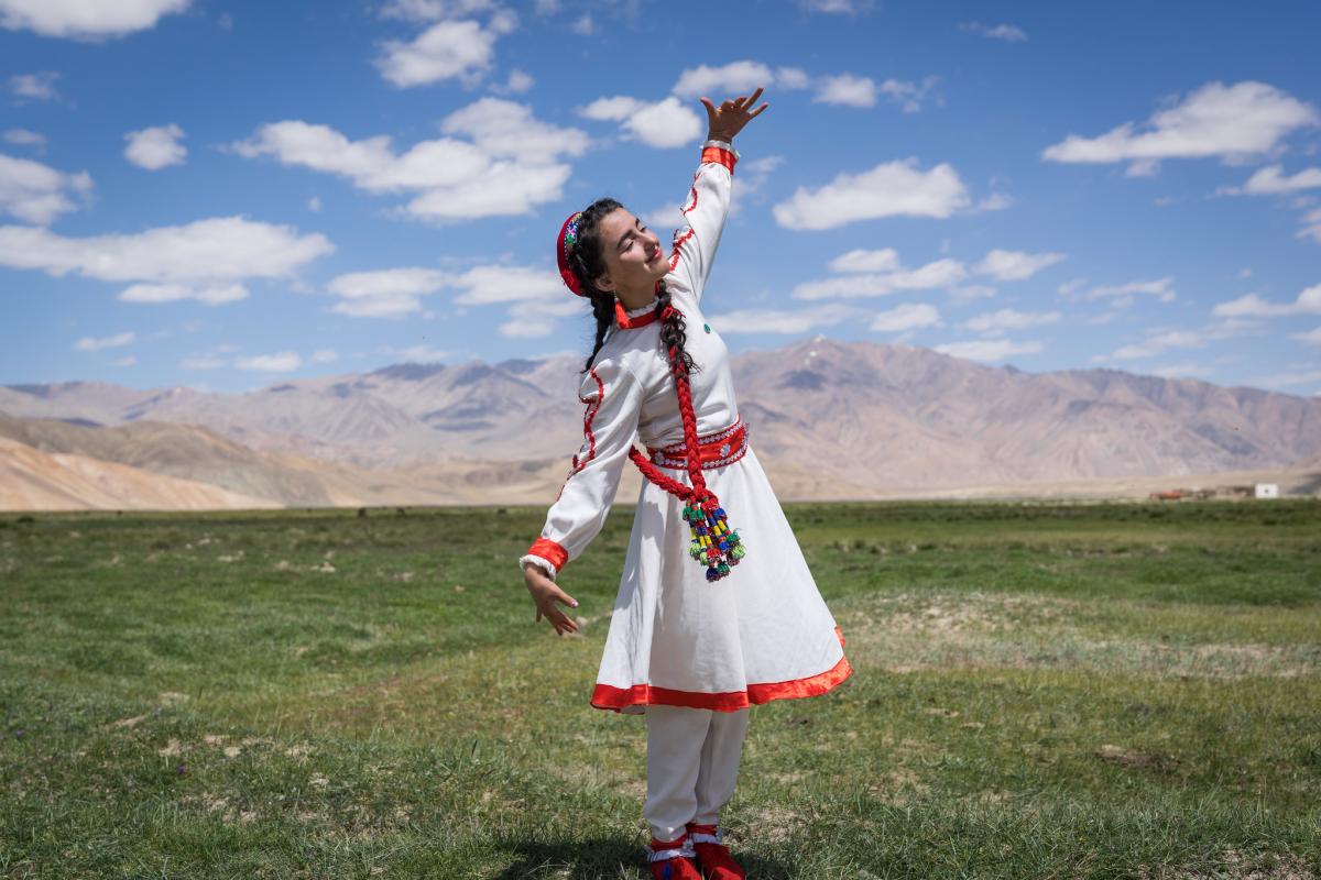 A girl in traditional Tajik dress dances at the opening of a new tourism centre in Bulunkul, a remote area in the Pamir mountains of Tajikistan. Photo Credit Christopher Wilton-Steer and AKDN