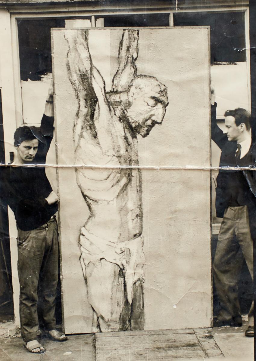 Anthony Whishaw (left) with his painting The Crucifixion 1956, 244 x 122 cm, oil on board during his time at the Royal College of Art. 