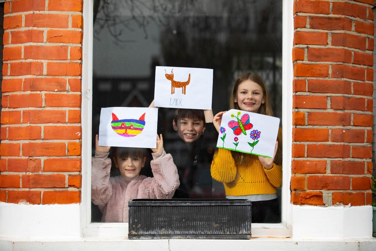 Artworks depicting animals, created by (left to right) Romey, Iggy and Louie is displayed in the windows of a house in Acton, London. Photo_ David Parry_PA Wire.JPG