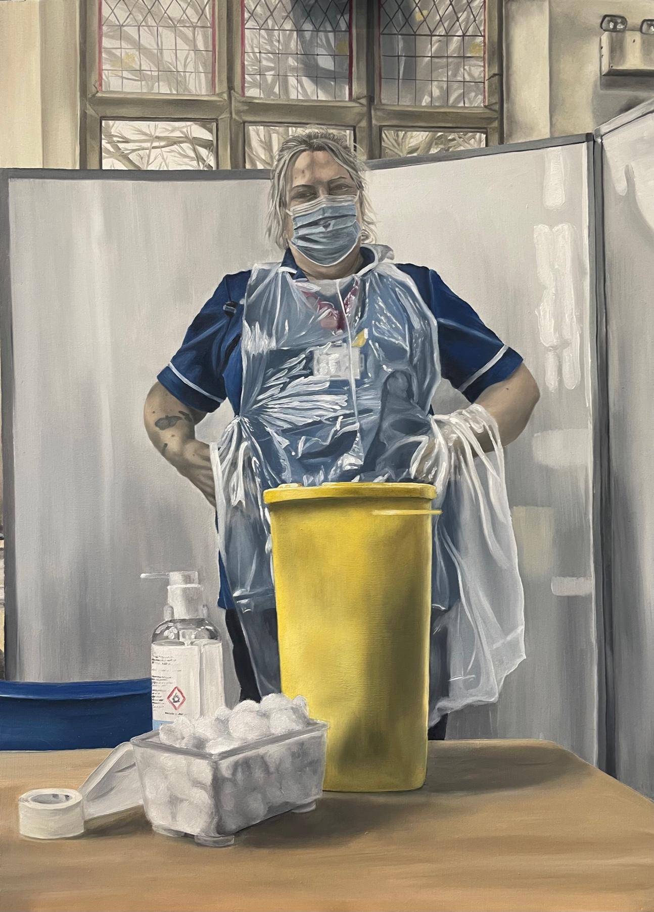 An oil painting of a woman with an NHS uniform including a mask and apron stands with her hands on her hips in a powerful stance, with equipment in front of her