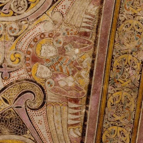 "Chi Rho Angels" two angels sit closely together. This is just one of the many small images, patterns, and designs found around and amongst the two greek letters "chi" (looks like an X) and "rho" (looks like a lower case P), which, stylised, form the main design elements of the Chi Rho page of The Book of Kells